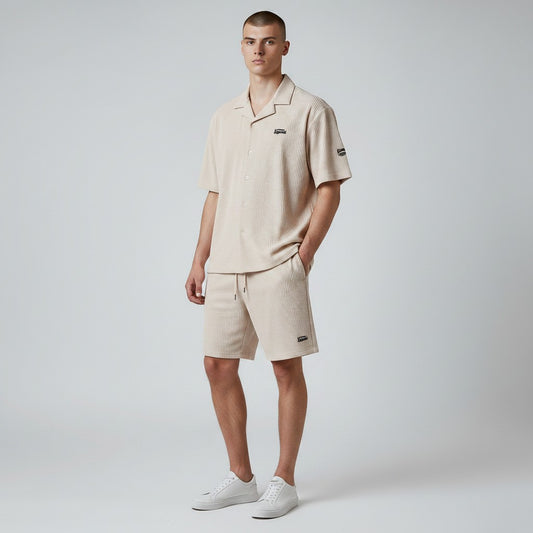 Klothco Kaporal beige textured short-sleeve shirt and drawstring shorts set worn by a male model.